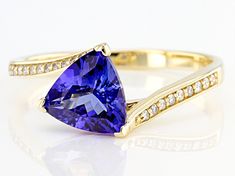 1.78ct Trillion Tanzanite And 0.10ctw Round White Diamond 14k Yellow Gold Ring. Measures Approximately 0.82"L x 0.34"W. Finished Under Gallery. Yellow Gold Tanzanite Birthstone Ring, Tanzanite Gemstone Rings In Yellow Gold, Luxury Tanzanite Yellow Gold Ring, Yellow Gold Tanzanite Ring With Polished Finish, Yellow Gold Tanzanite Multi-stone Ring, Blue Tanzanite, Tanzanite Ring, Latest Jewellery, White Diamond