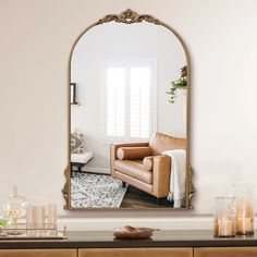 a living room scene with focus on the couch and large mirror