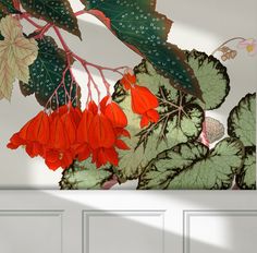 a painting of red and green leaves on a white wall