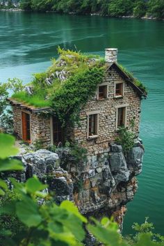 a small house built into the side of a cliff with plants growing out of it