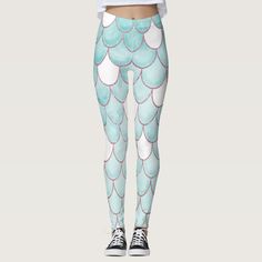 the leggings are designed to look like fish scales, with white and blue colors