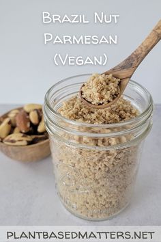 a jar filled with granola next to a wooden spoon