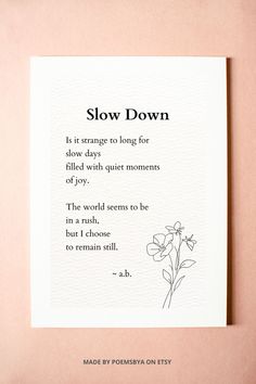 a card with the words slow down written in black and white on it, next to a pink background