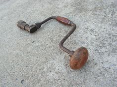 an old rusted metal object laying on the ground