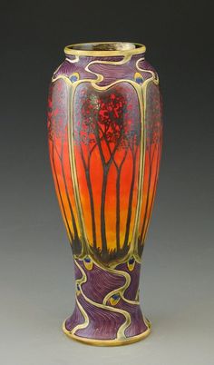 a colorful vase with trees painted on it