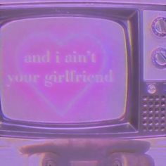 an old tv with the words and i am not your girlfriend on it's screen