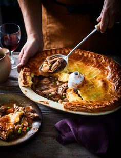 a person scooping some food out of a pie