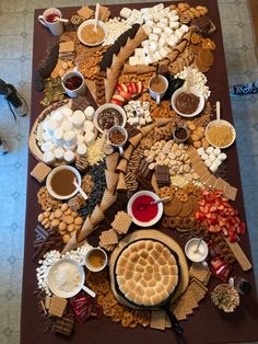 a table topped with lots of different types of food and desserts on top of it