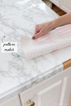 a person is using a piece of paper on top of a marble countertop with the words pattern in matter written across it