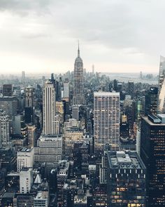 an aerial view of new york city with skyscrapers in the foreground and empire building on the far side