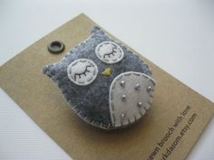 an owl brooch sitting on top of a card