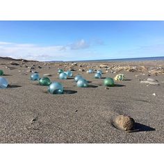 there are many glass balls on the beach