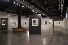 an art gallery with black and white pictures on the walls