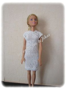 the doll is wearing a white dress