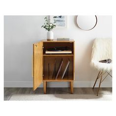 a wooden cabinet sitting next to a white chair