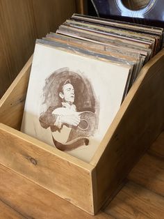 an old record player's album collection in a wooden box