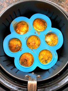 several muffins are in the middle of an air fryer