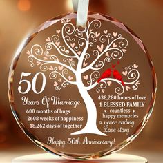 a personalized glass ornament with a tree and birds on it for 50th anniversary