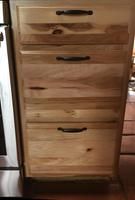 a wooden dresser sitting on top of a hard wood floor