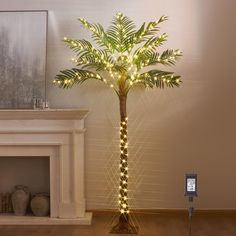 a lighted palm tree next to a fireplace