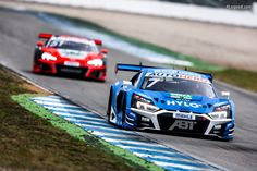 two racing cars driving on a race track