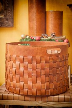 a leather basket is sitting on top of a table