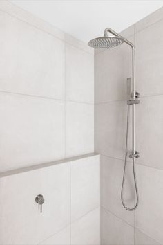 A brushed nickel all in one shower set is installed on a wall with a ledge and light grey, neutral toned tiles. Brushed Nickel Shower, Japanese Style House, Passive Solar Design, Solar Design, Attic Space, Internal Courtyard