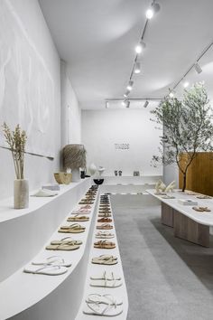 a room filled with lots of white tables and vases on top of each other