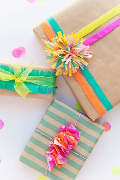 two wrapped presents with colorful ribbons on them