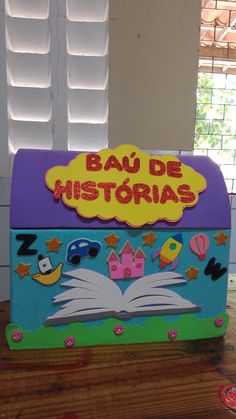 a wooden box with an open book on top of it that says bau de historis