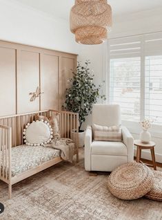 a baby's room with a crib, chair and rug