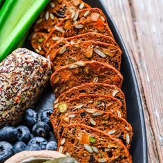 sliced carrot bread with blueberries, celery and almonds on a plate