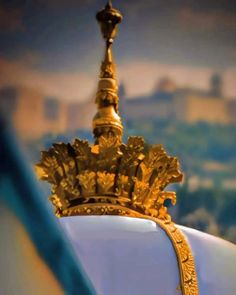 a gold crown sitting on top of a white chair