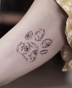 a dog paw tattoo on the right arm