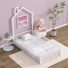 a small white bed in a room with pink walls and wooden flooring next to a plant