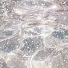 an image of water with bubbles and sparkles on the surface, as seen from above