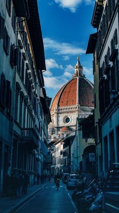 an alley way with buildings and a dome on the top of it's roof