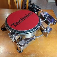 a turntable sitting on top of a wooden table with the word technic printed on it