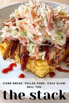 a plate with cornbread bread, pulled pork cole slaw and the stack on it