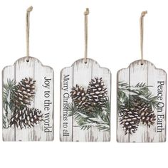 three wooden tags with pine cones on them