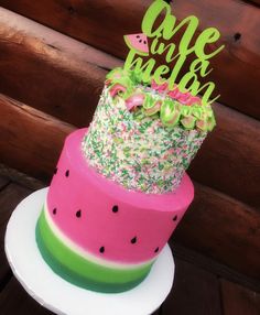 a watermelon cake with the words one in melon on top and sprinkles around it