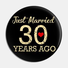 a black button with the words just married 30 years ago and a red heart on it