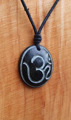 Om pendant hand-carved from natural stone called green granite by myself. The stone is similar to soapstone but more hard and durable then the soapstone. The size of this pendant is approximately 2.7cm x 2.2cm (1 x 0.9inches). It is hung on an adjustable waxed cotton black cord which is included free of charge. Not only are these pendants a beautiful thing to wear as part of your jewellery collection, but they are also very pleasing to the touch. The weight and smoothness of the hand carved ston Carved Stone Jewellery, Symbolic Carved Necklace For Gifts, Spiritual Carved Necklace For Collectors, Stone Carved Necklace, Carved Amulet Jewelry For Gifts, Om Pendant, Hand Carved Stone, Rock Jewelry, Dragon Pictures