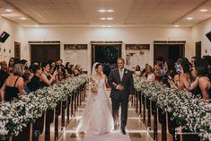 the bride and groom are walking down the aisle