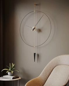 a clock mounted to the side of a wall next to a chair and potted plant