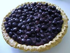 a blueberry pie sitting on top of a table