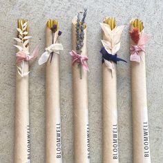 five different types of flowers wrapped in brown paper