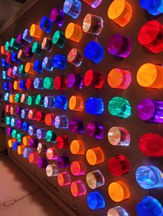 a wall with many different colored lights on it