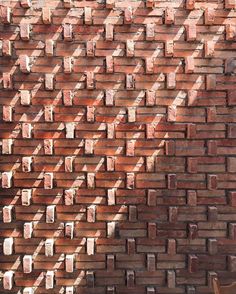 a brick wall that has been made into a pattern in the shape of squares and rectangles