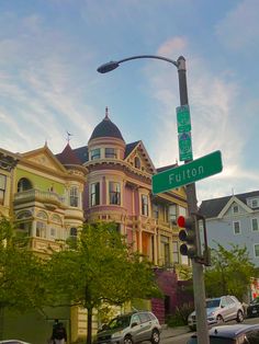 a street sign that is on the side of a pole in front of some houses